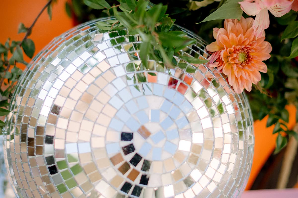 Mirrored disco ball nestled among peach and pink florals.