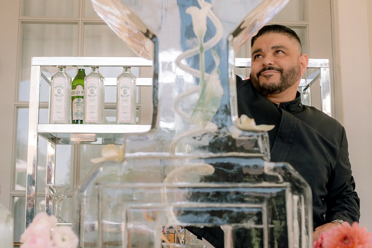Martini-glass ice luge carved with the couple’s A and C monogram as a bartender pours a drink.