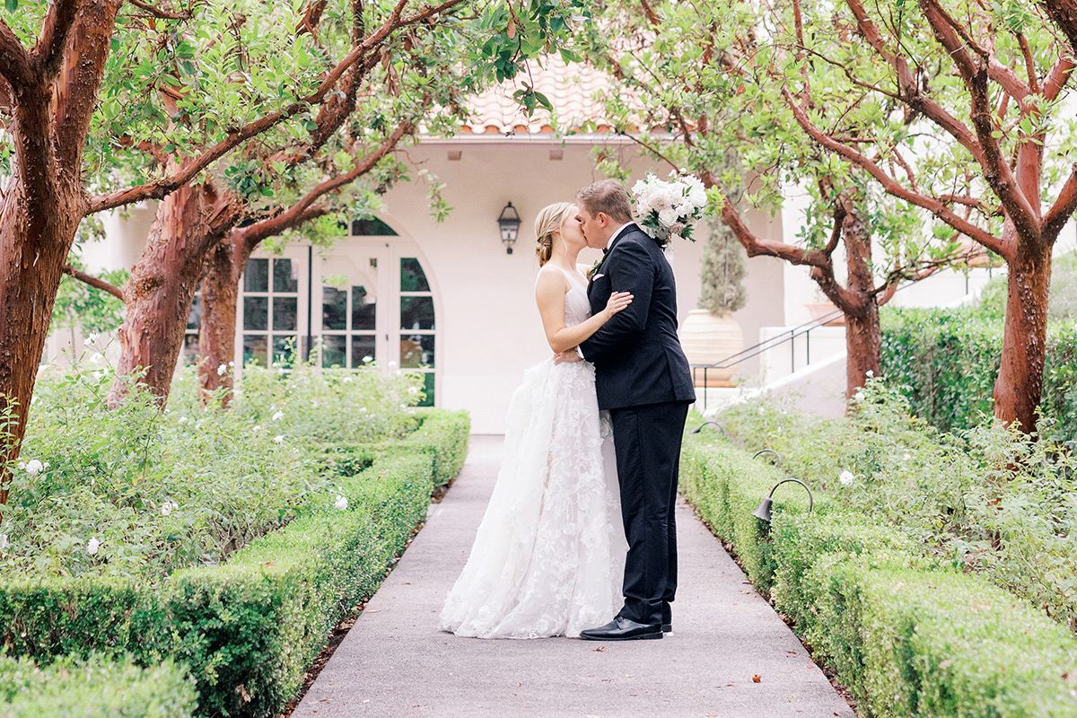 Annie and Zach during garden portraits at their Rancho Bernardo Inn wedding in San Diego, planned by Bliss Events.