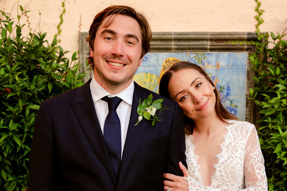 Oi and Halston posing together outdoors after their wedding ceremony.