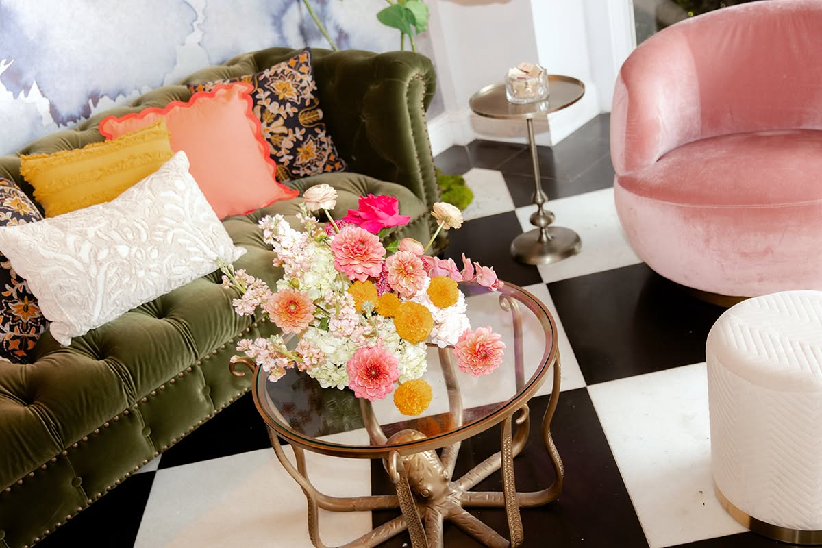 Reception lounge seating with a floral arrangement and colorful accent pillows.