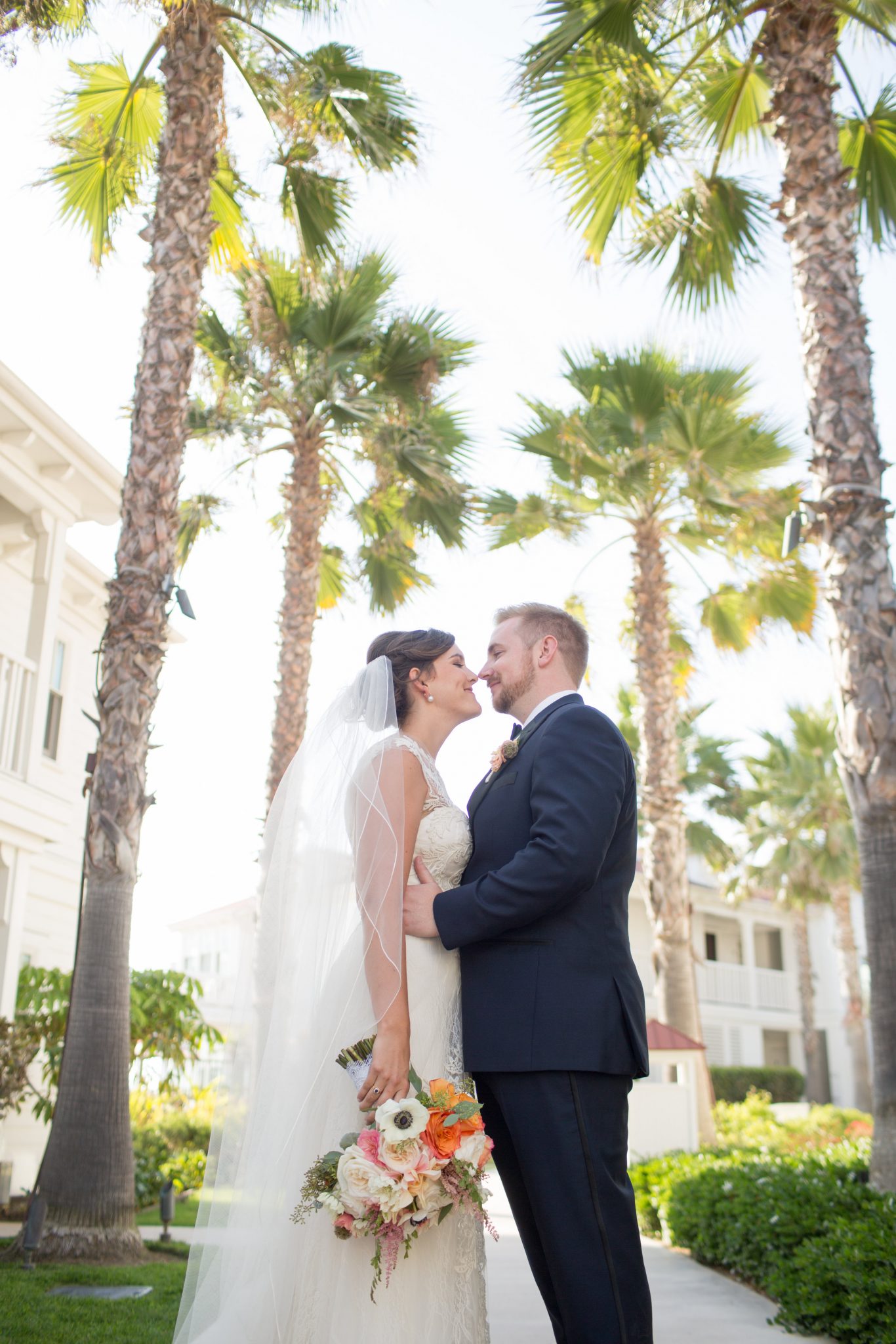 Leslie and Noah embracing during their Beach Glamour wedding at the famous Hotel Del Coronado