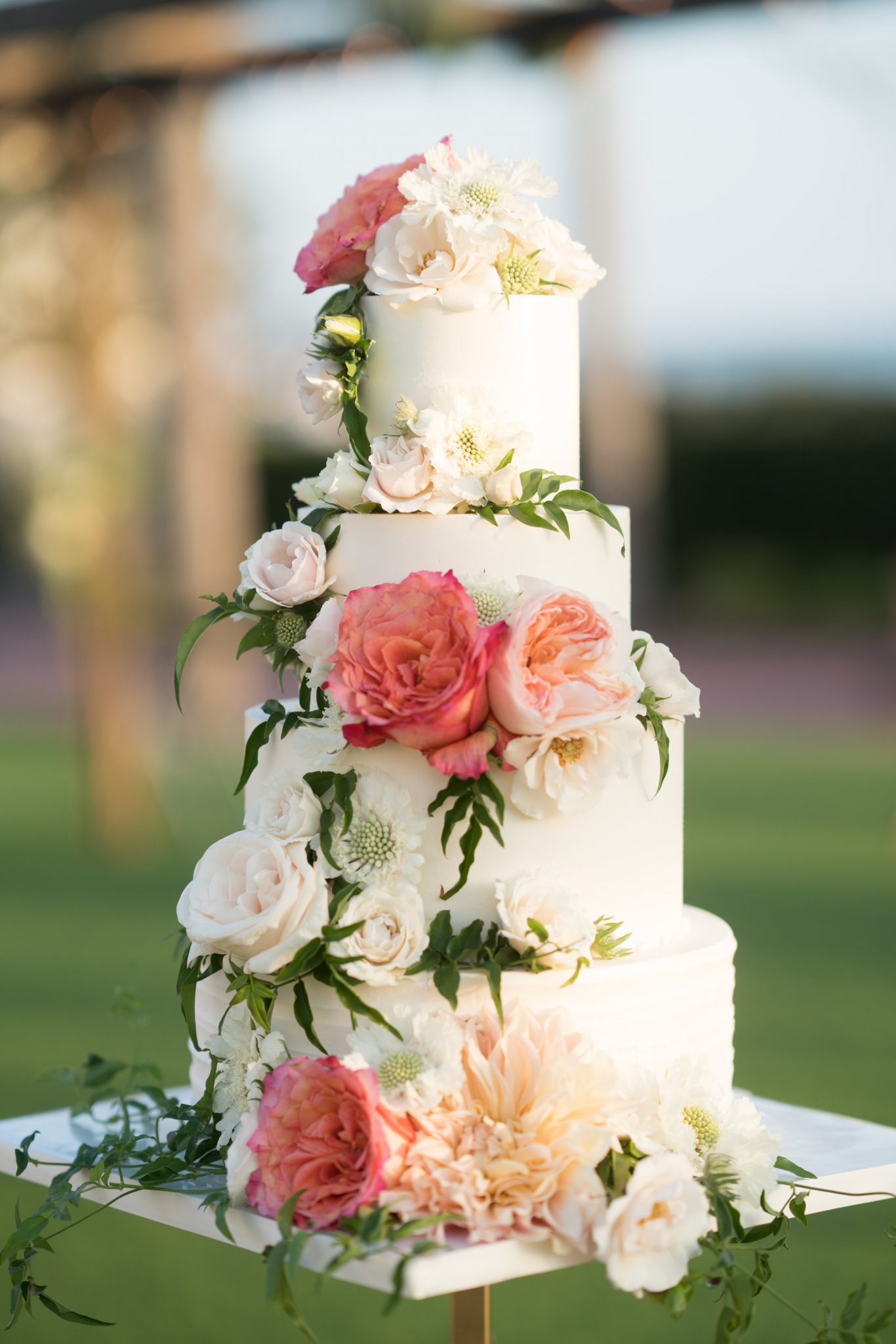 Amazing tiered wedding cake created by Organic Elements with flowers