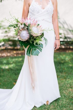 Kelly with her amazing flowers from Isari Flower Studio in a white wedding dress