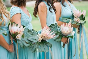 Bridesmaids in blue dresses with amazing floral arrangements